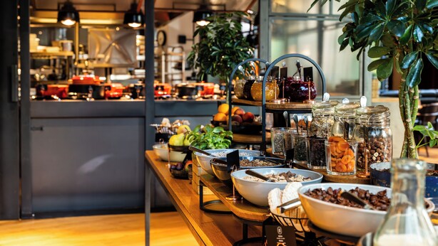 A buffet with various food items and condiments. - The Bridge Wroclaw - MGallery (Wroclaw)