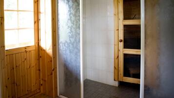Cozy retreat with a wooden door, window, and tile floor.