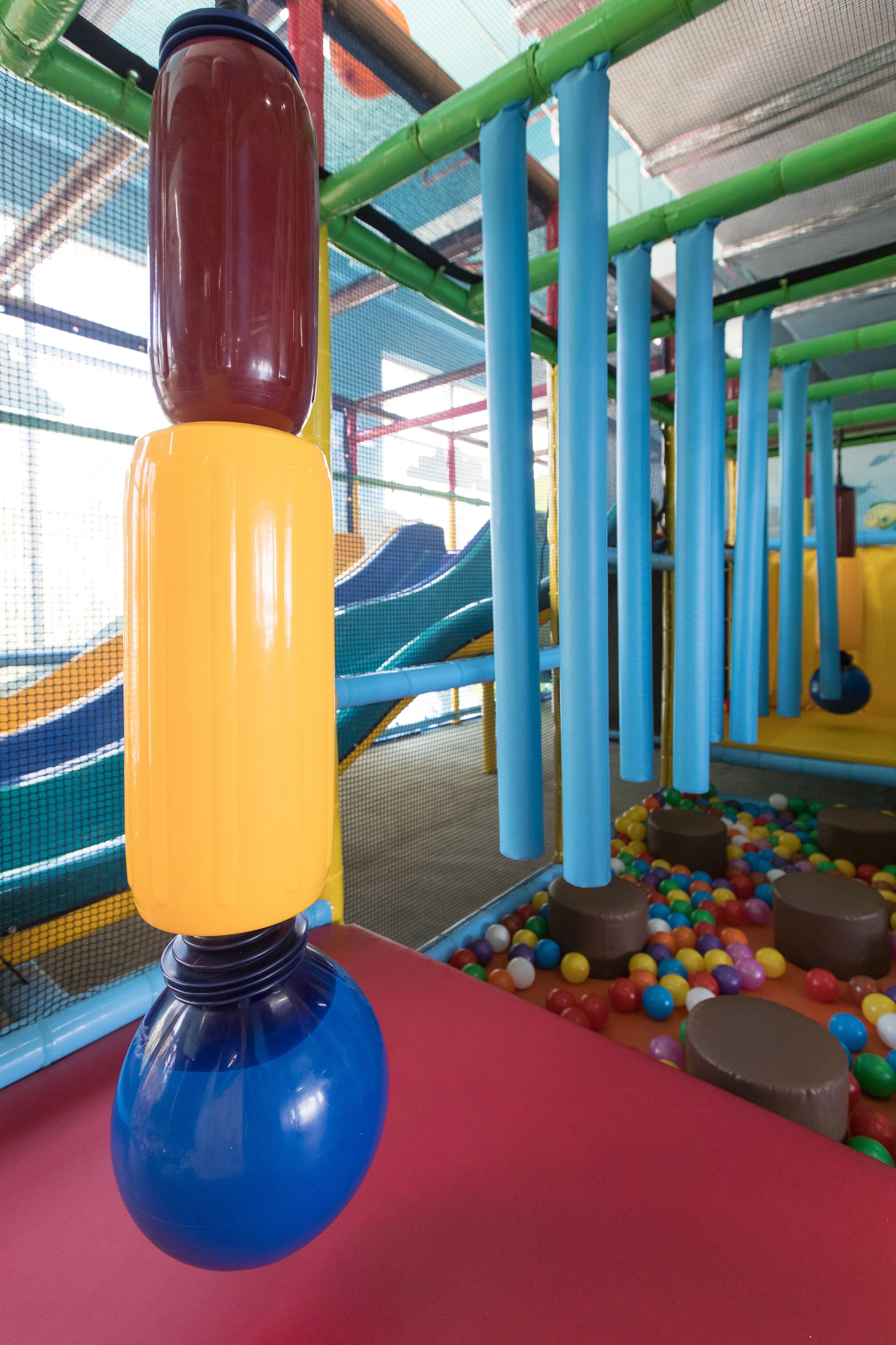 A play structure with colorful slides and a ball pit.