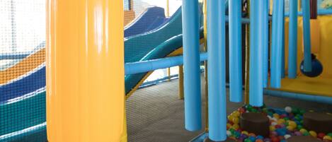 A play structure with colorful slides and a ball pit.