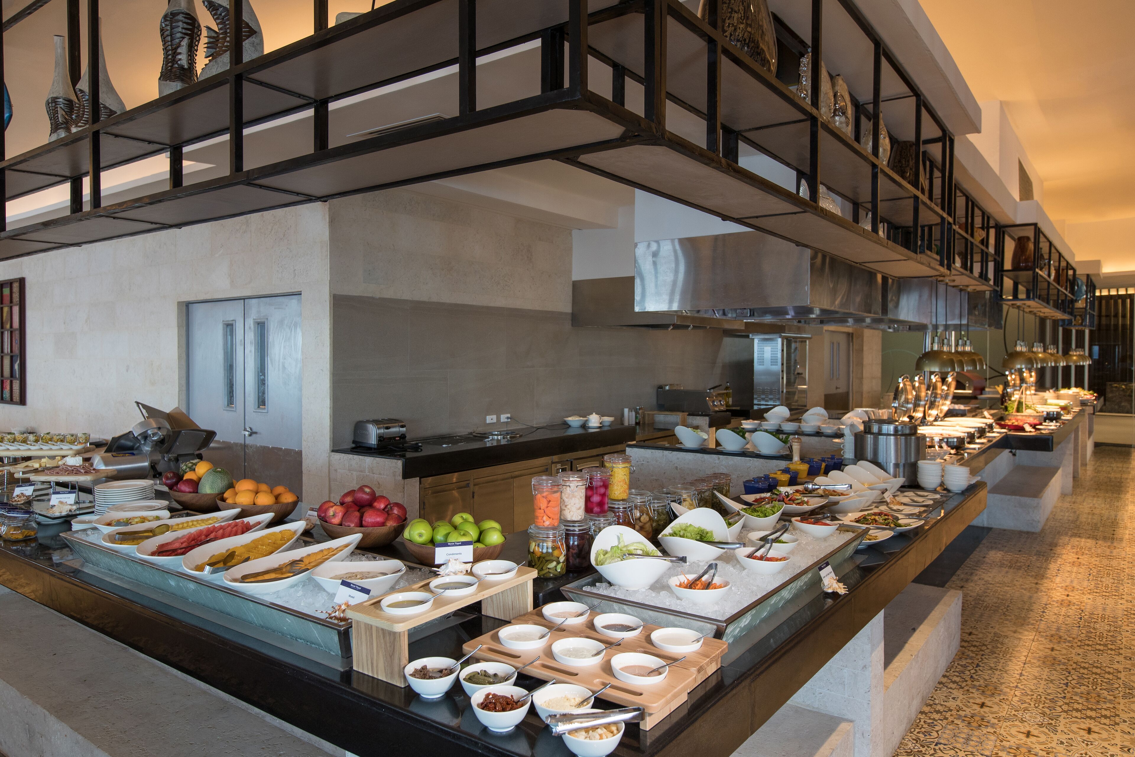 A buffet setup with various food items and condiments.