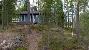 A cabin surrounded by dense forest with a dirt path leading to it. - Salkolahti Tikkamaki (Orivesi)