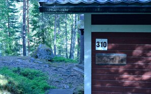 Una cabaña con un cartel con el número '310' y un letrero de madera que indica 'Fontville'.