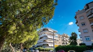 A multi-story residential building with balconies and a clear blue sky. - Taurus - Deluxe Apartment with Sea View (Glyfada)