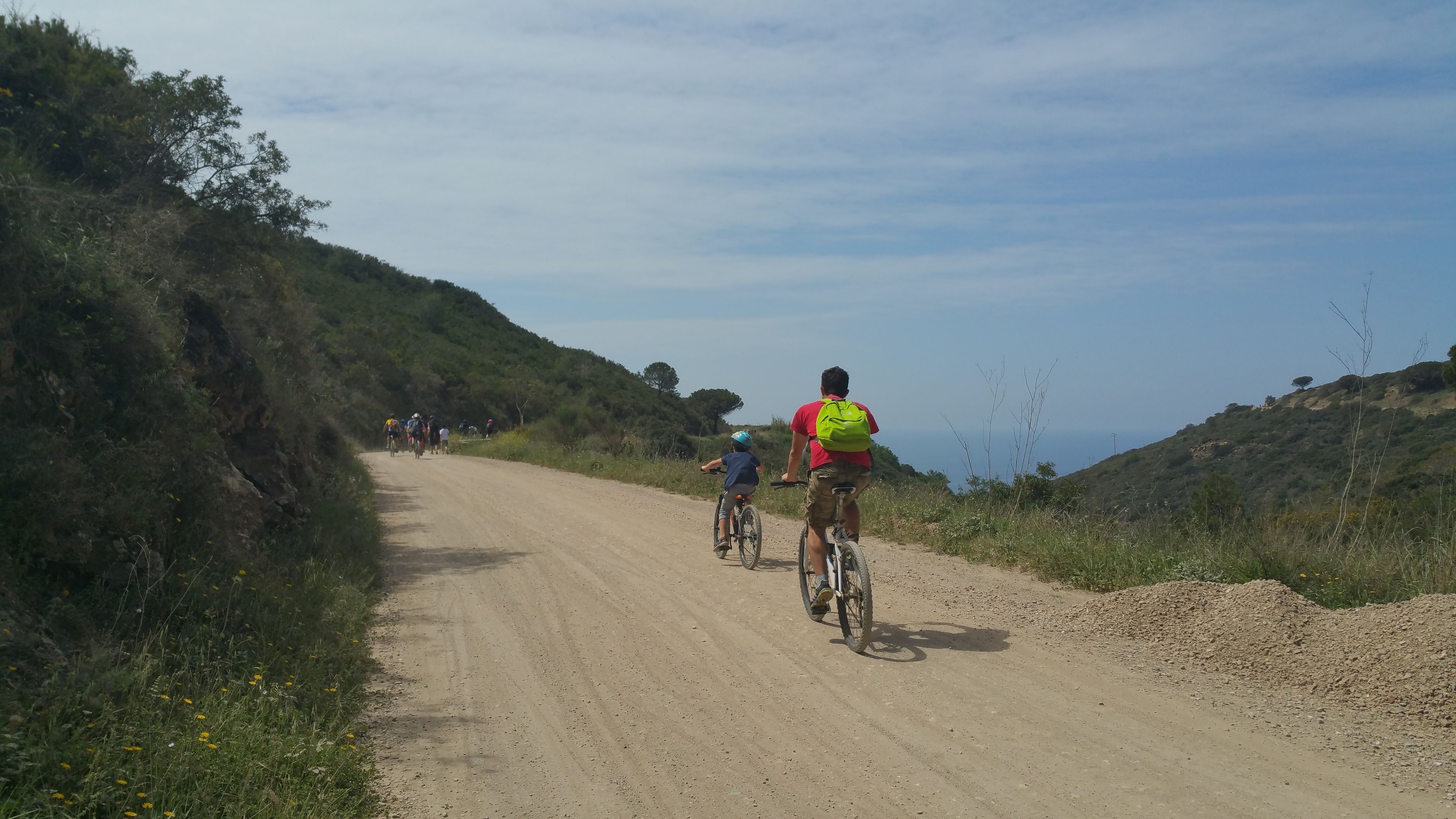 A dirt road with cyclists.