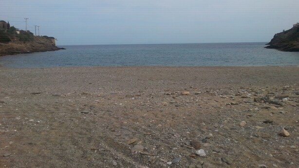 A rocky beach with a calm sea and a clear sky. - Villa V (Lavreotiki)