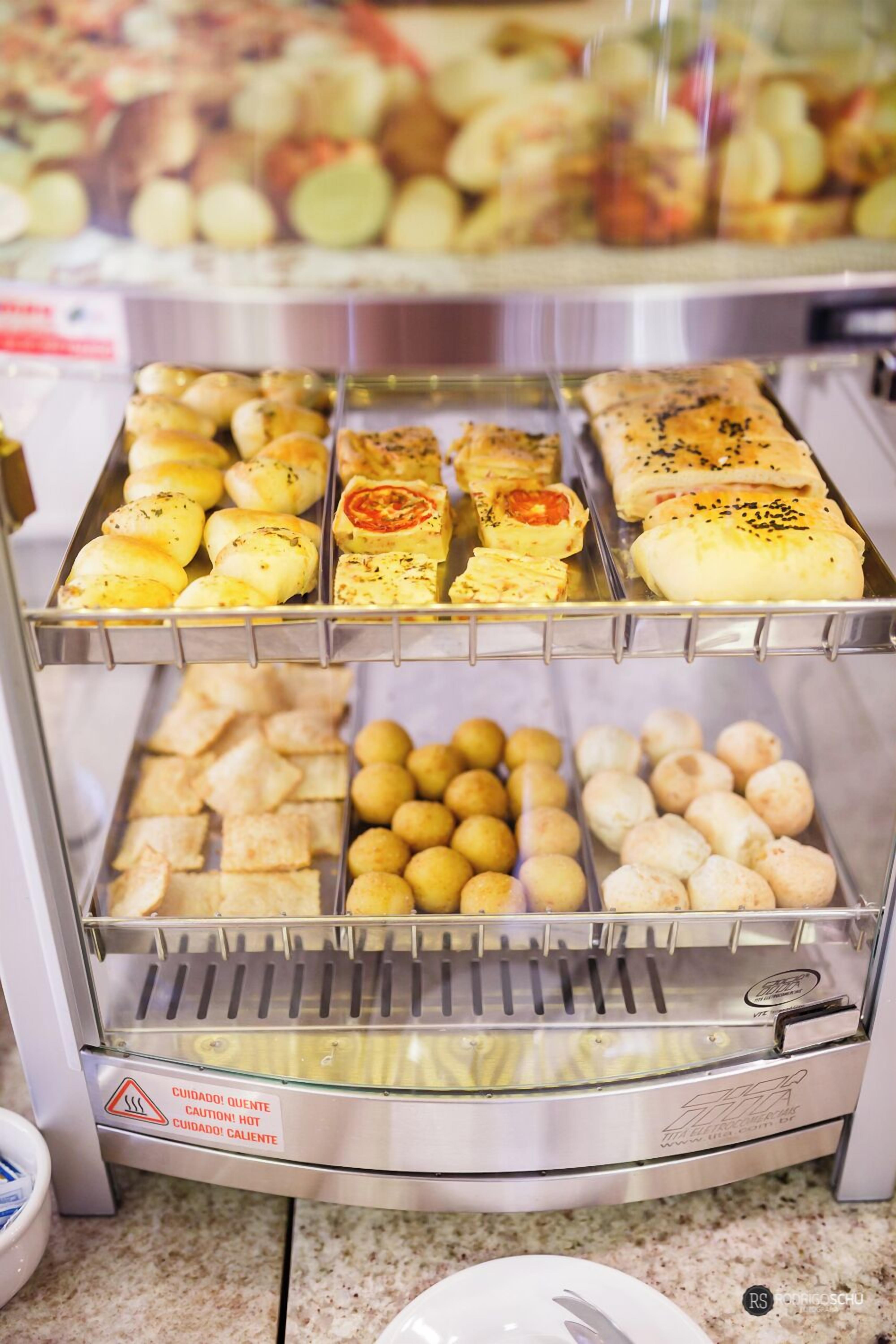 A display case with various baked goods, including bread rolls and pastries.