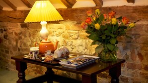 A table with a lamp, teapot, cups, and a tray of food items. - Colston Hall Farmhouse B&B (Woodbridge)