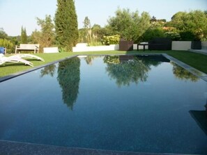 Seasonal outdoor pool, open 9:00 AM to 7:00 PM, pool loungers