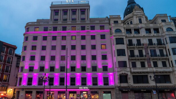 A hotel with a classic architectural style, featuring a prominent dome and a statue on top. - NYX Hotel Bilbao by Leonardo Hotels (Bilbao)