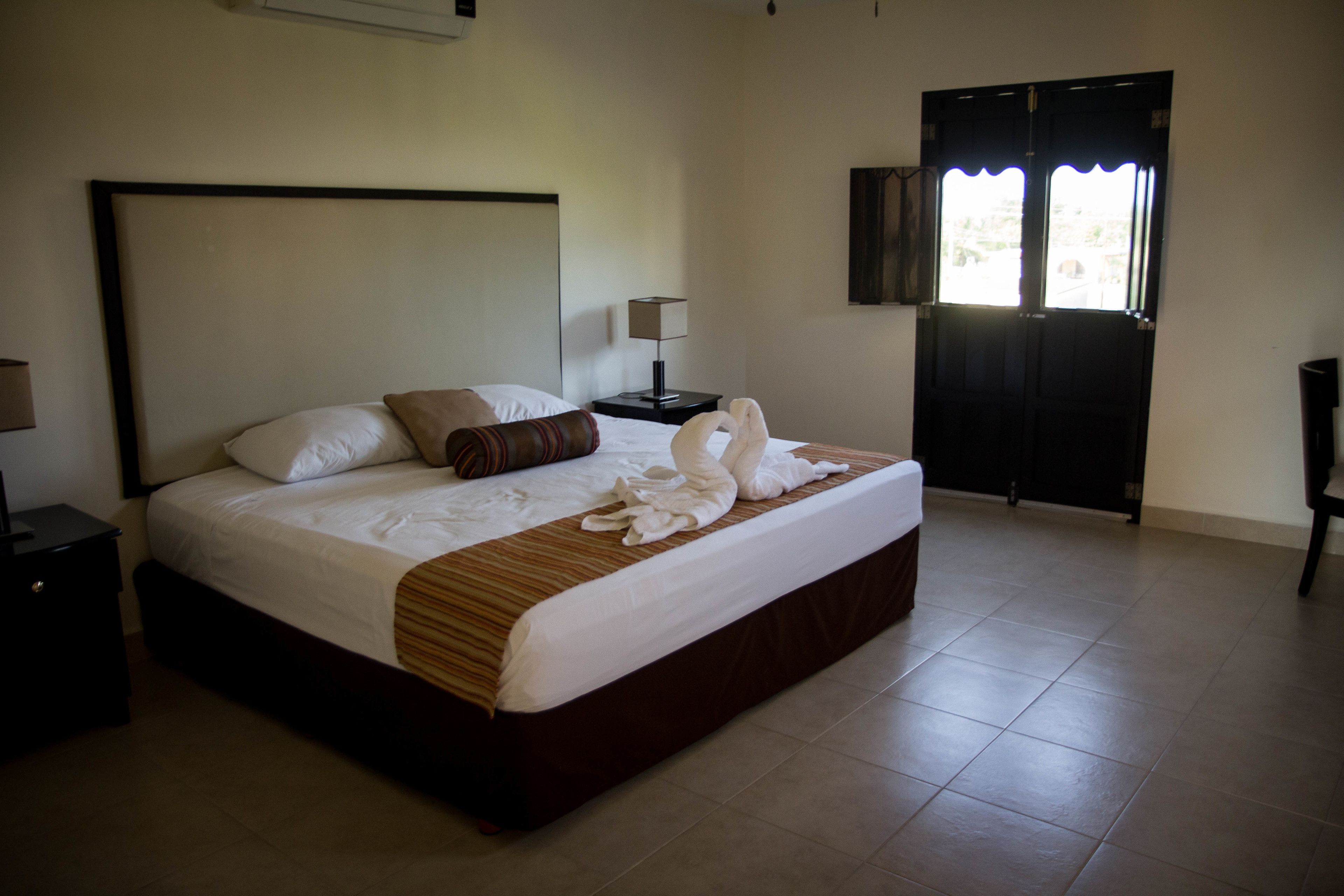 junior room, 1 king bed, non smoking, garden view | iron/ironing board, free wifi, bed sheets