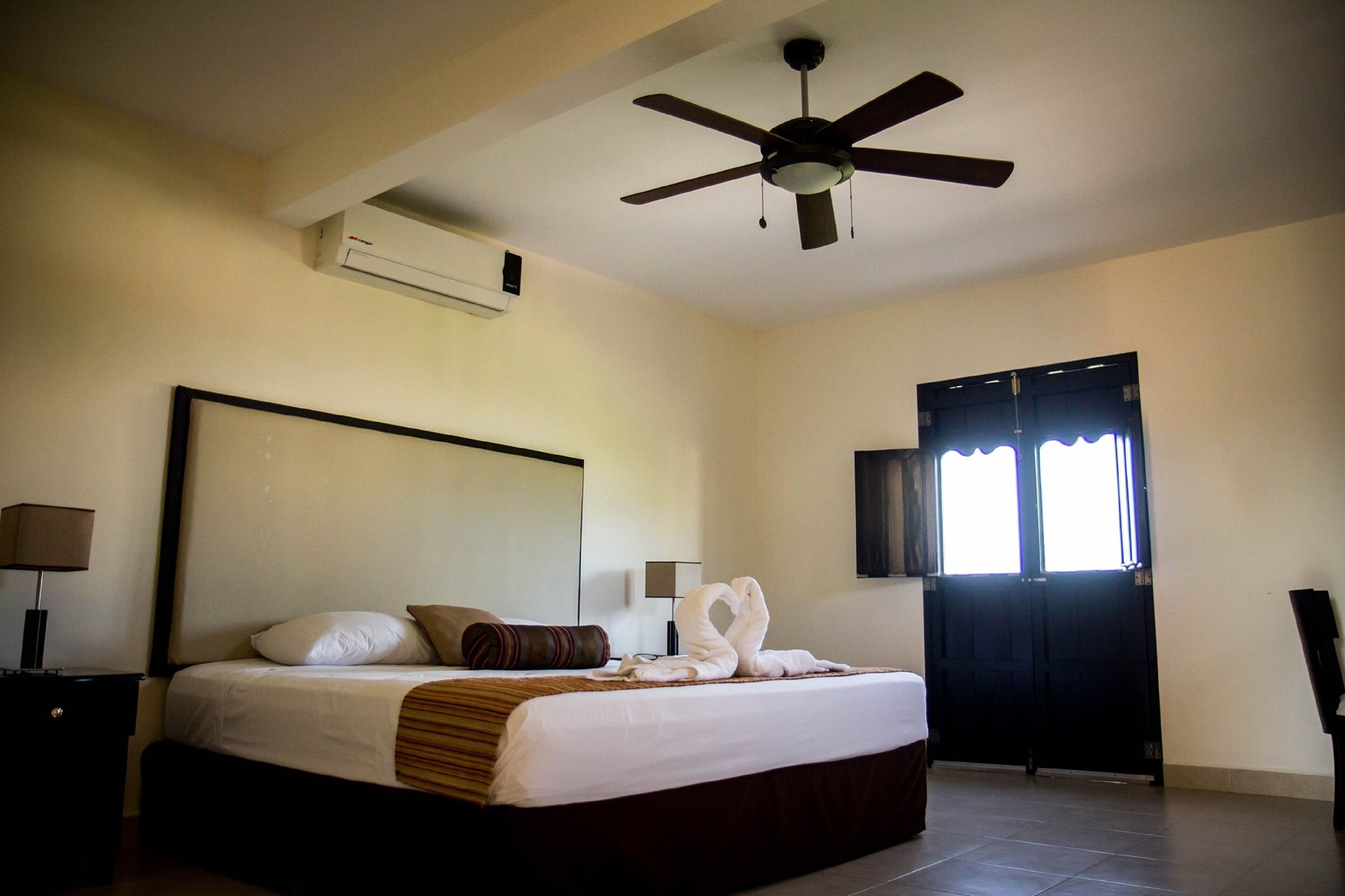 junior room, 1 king bed, non smoking, garden view | iron/ironing board, free wifi, bed sheets