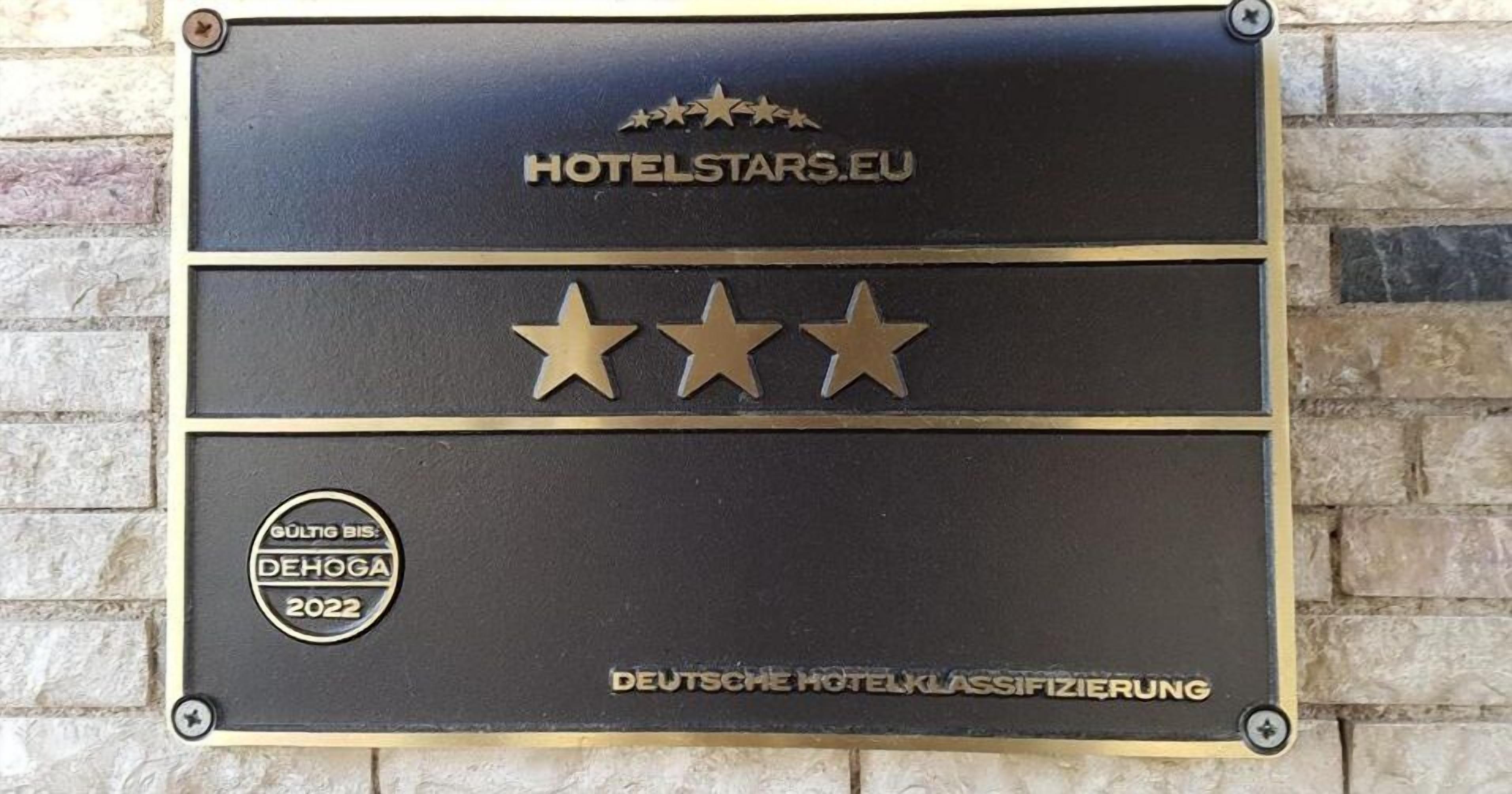 A plaque with the text "HOTELSTARS.EU" and three gold stars, indicating a hotel rating.