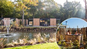 A modern outdoor area with a pond, wooden deck, and a hot tub.