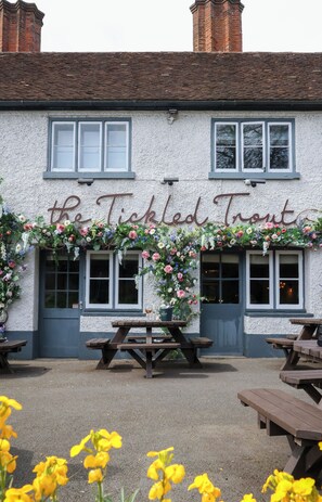 A building with a sign reading "the Tickled Trout" and outdoor seating. - The Tickled Trout (Maidstone)