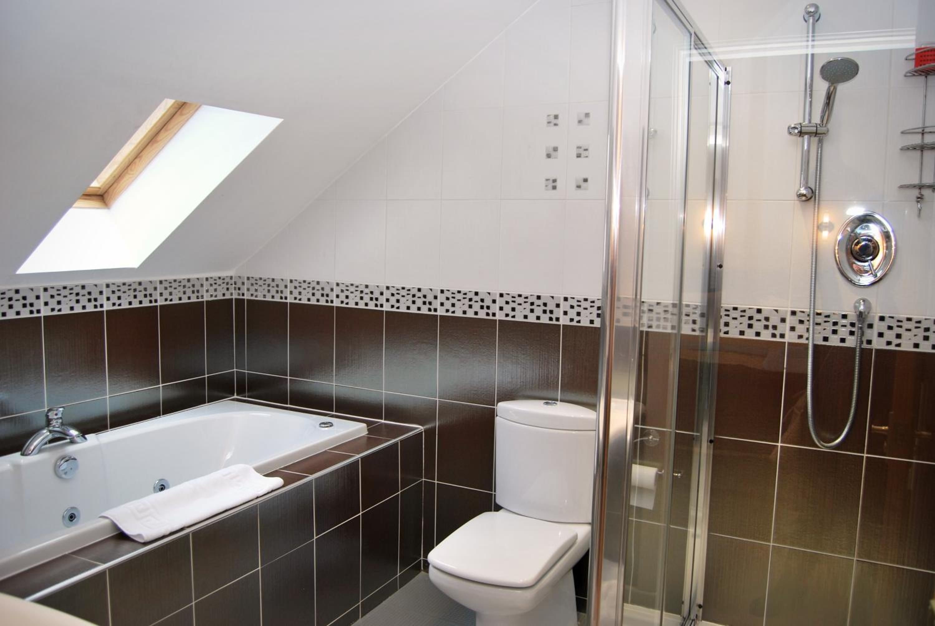 Un baño con bañera, inodoro y ducha.