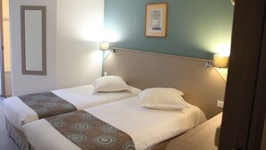 A hotel room with two beds, a framed picture on the wall, and two wall-mounted lamps. - Doubs Hotel - Hostel (Ecole-Valentin)