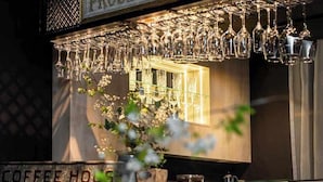 A bar area with a sign reading 'The Prosecco Bar' and a coffee house sign below.