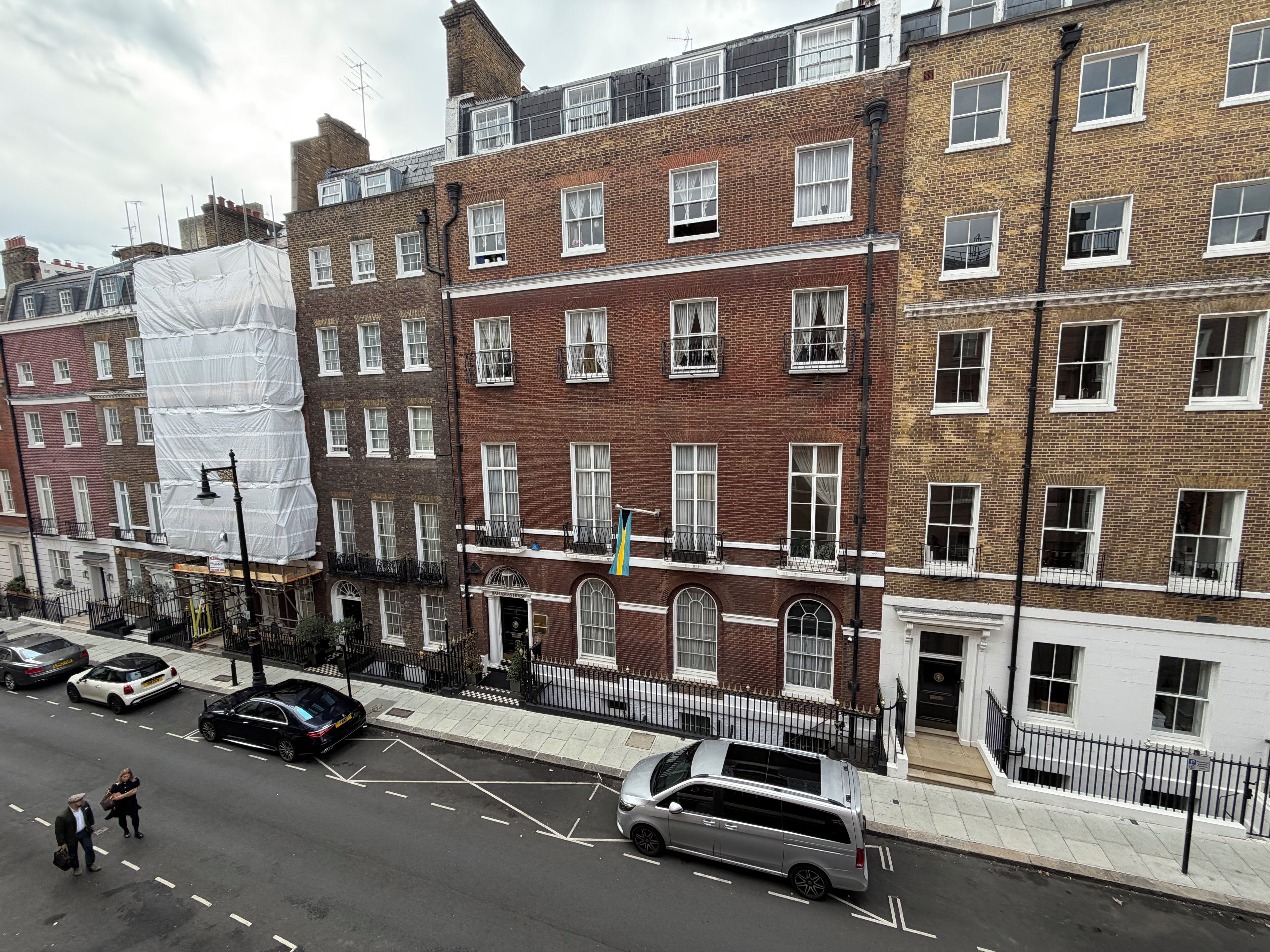 A row of terraced houses with brick facades and white window frames.