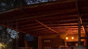 An outdoor seating area with a fire pit and a covered patio. - La Masía Hotel Boutique (Chacras de Coria)