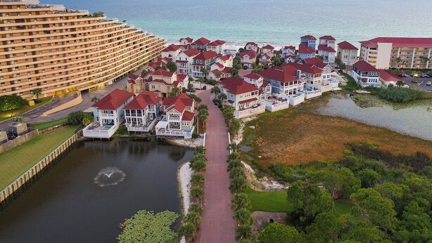 A coastal resort with a marina, beachfront villas, and a large hotel. - Aria Del Mare - Beach House with Ocean Views & Private Pool Area (Miramar Beach)