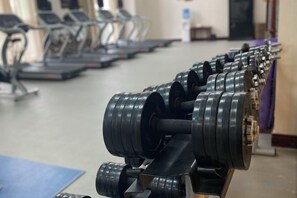 A row of dumbbells on a rack in a gym. - Zhongjia Palace Hot Spring Hotel (Beijing)