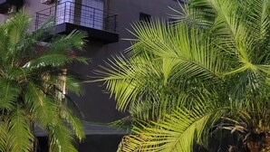 A modern hotel building with balconies, a prominent 'HOTEL' sign, and the name 'MAISON' on the facade. - Maison Hotel (Tangará da Serra)