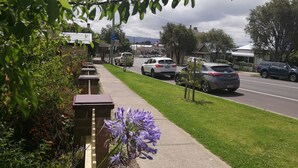 A street view with parked cars, a sidewalk, and buildings in the background. - 125 Milton (Milton)