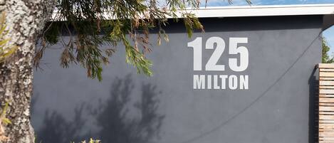 A building with the number 125 and the word "MILTON" on its facade.