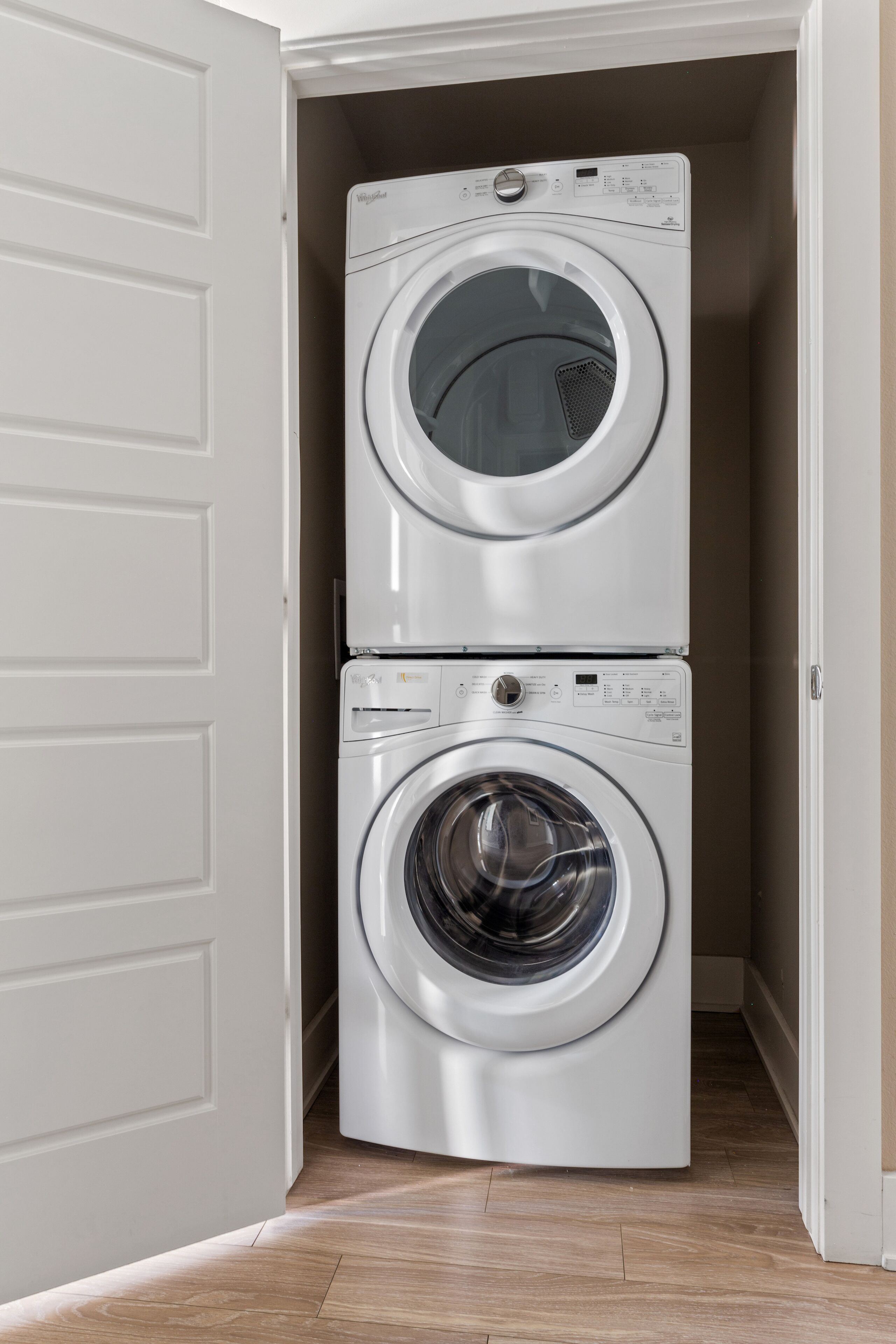 A laundry room with two stacked front-loading washing machines.