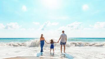 On the beach, white sand, sun-loungers, beach umbrellas