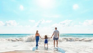 On the beach, white sand, sun loungers, beach umbrellas