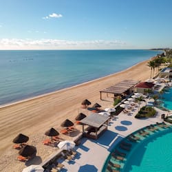 On the beach, white sand, sun loungers, beach umbrellas