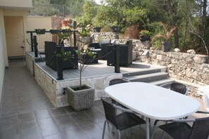 Relax on the patio surrounded by lush greenery and enjoy the serene atmosphere.