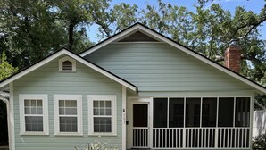 A single-story house with a front porch and a covered patio area.