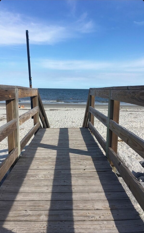 Walk along the boardwalk to the sandy beach.