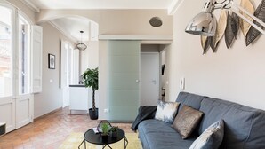A modern living room with a grey sofa, a black coffee table, and a potted plant. - Maison Babuino with a panoramic terrace (Roma)