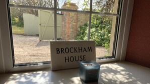 A window sill with a sign reading "BROCKHAM HOUSE" and a candle. - Georgian House with Indoor Swimming Pool (Willsbridge)