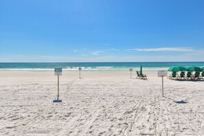 A beach with signs indicating it is a private beach, no setups allowed, and owned by Martinique. - Luxurious, tropical condo w/panoramic views of the water! (Destin)