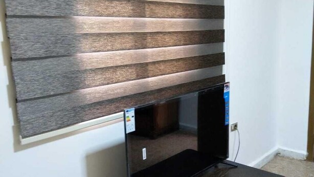 A room with a built-in TV shelf and a small table.