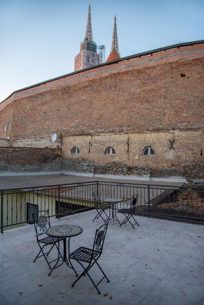 Guests can sit and enjoy the view of the nearby church spire in this peaceful courtyard.