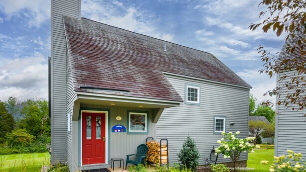 A two-story house with a red door, a welcome sign, and a small porch area. - Enjoy each season's weather in historic Manchester.   Plenty to do year round!! (Manchester)