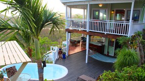 A two-story house with a balcony, a swimming pool, and outdoor furniture. - 4 bedroom, 4 bathroom. Private Pool, Ocean views. Chocolate Hole, Cruz Bay. (St. John, VI)