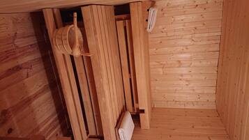 Una sauna de madera con bancos y un banco de madera.