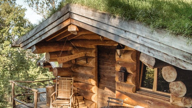 A rustic cabin with a wooden deck, a dining table, and a cozy seating area. - Log cabin Les Convers (Collonges-sous-Salève)