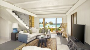 A modern living room with a sofa, coffee table, and TV, overlooking a beach.