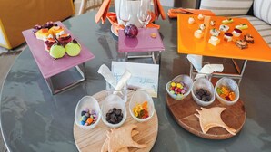 A table with various food items and a bottle of champagne.