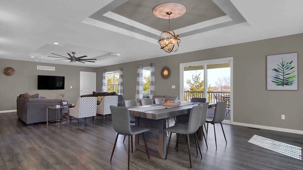 A spacious living area with a dining table, chairs, a sofa, and a ceiling fan. - The Bittersweet Inn: Brand new 6 bed 5 bath house (Hermann)