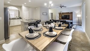 A modern kitchen with a dining area set for six.