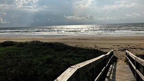 A wooden boardwalk leading to a beach with a view of the ocean and clouds in the sky. - Phoenix Rising - Chill Beach Vibes, 4 Decks! (Surfside Beach)